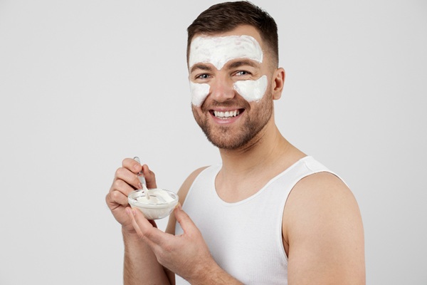 Hombre aplicándose remedios naturales en el rostro como parte de la rutina diaria de skin care para el rejuvenecimiento facial